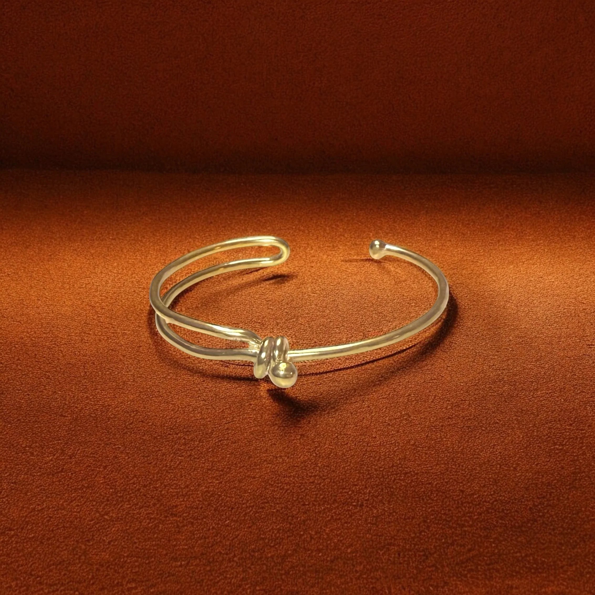 Gold bracelet on a brown background