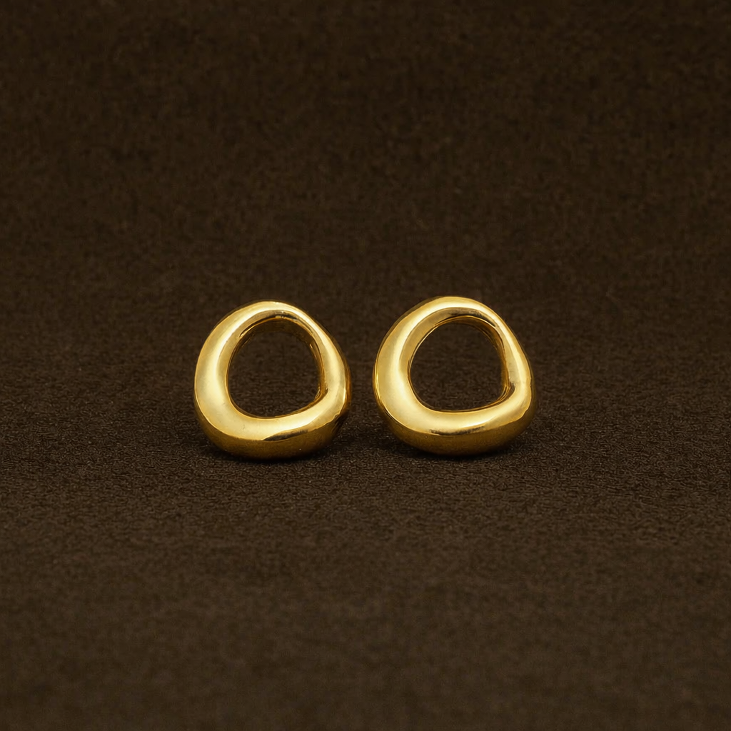 Pair of gold hoop earrings on a brown background