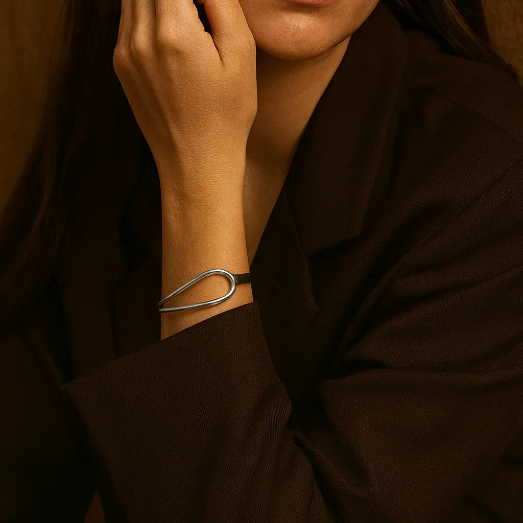 Woman with hand near face against a brown background