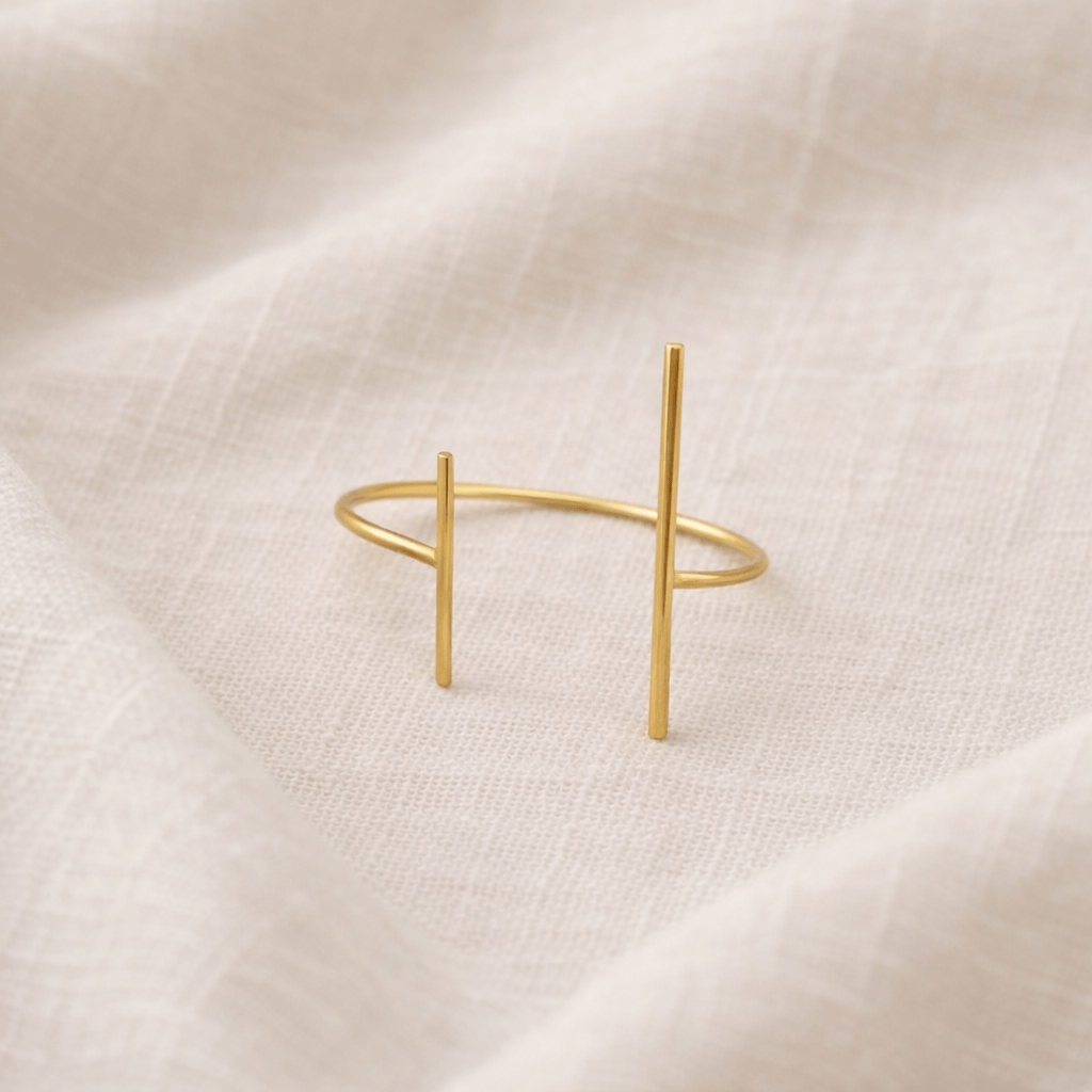 Gold bracelet on a beige fabric background