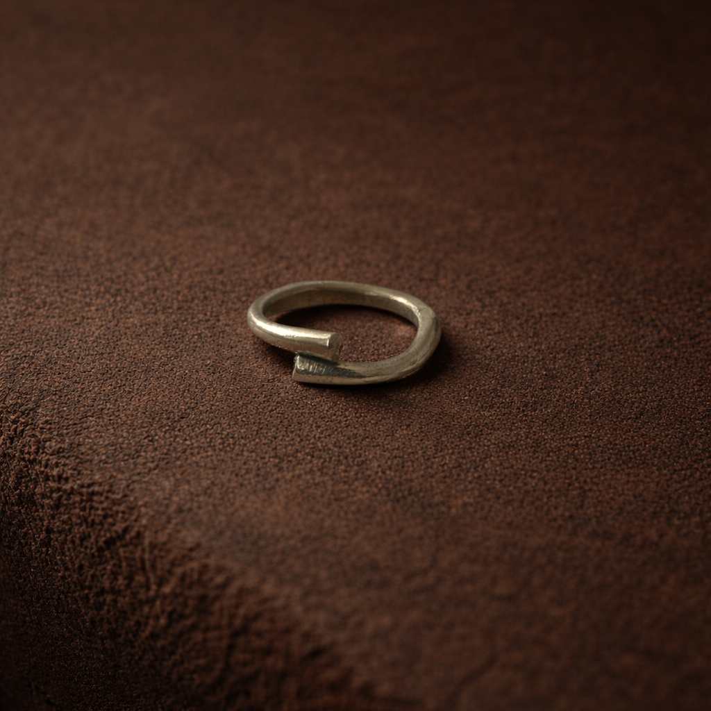 Silver ring on a brown textured surface