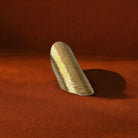 Wooden object on a textured red surface