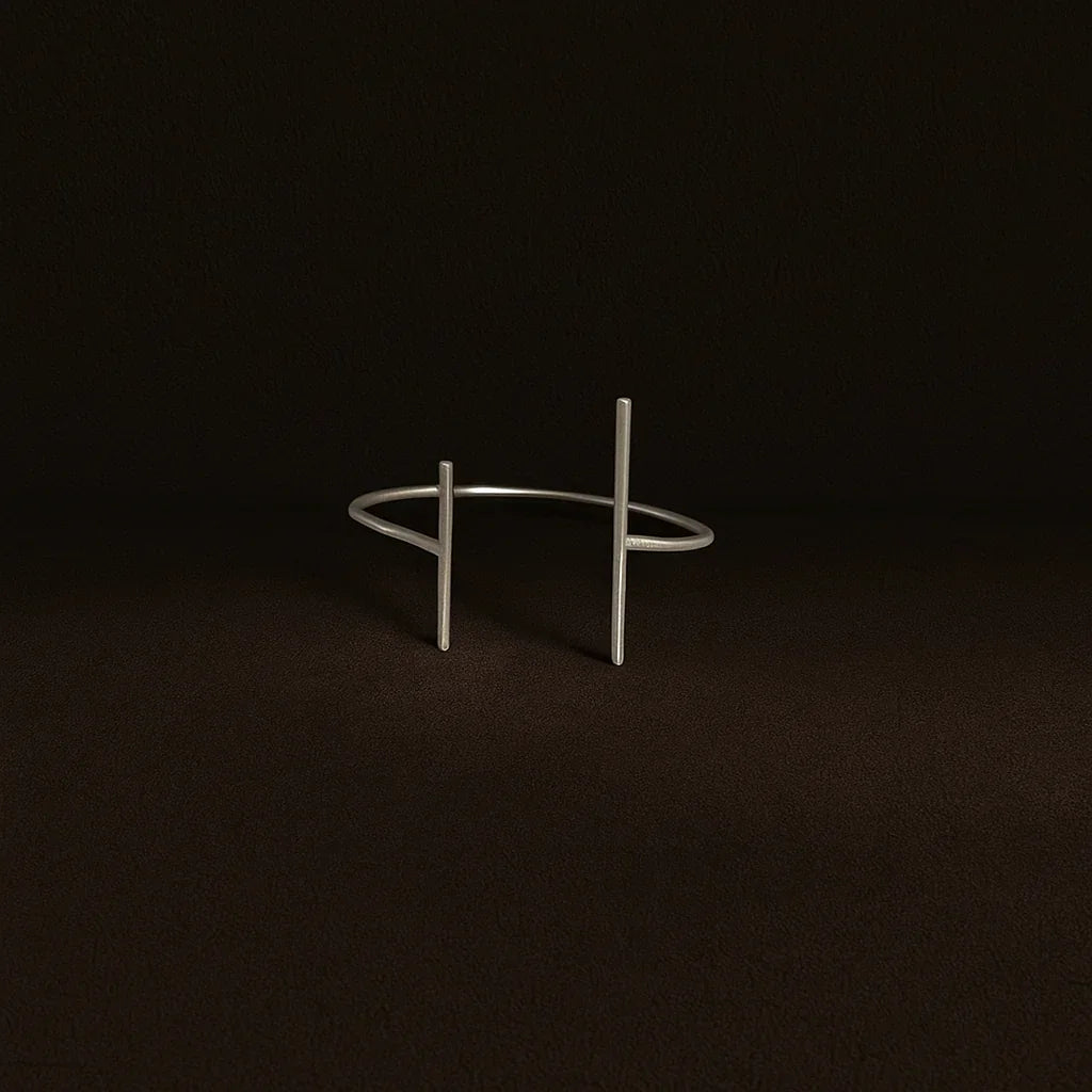 Silver bracelet on a dark brown background