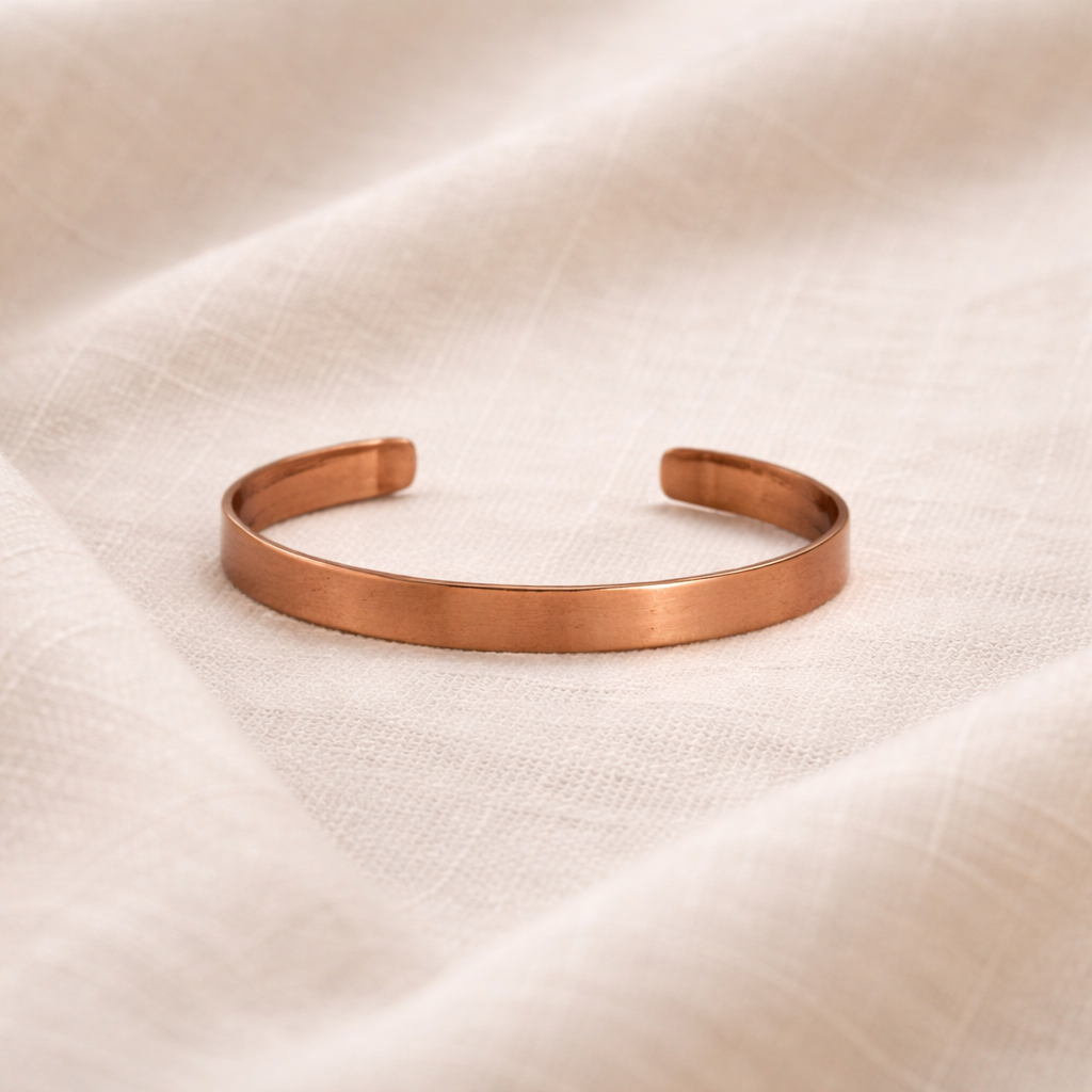 Copper bracelet on a beige fabric background