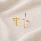 Gold bracelet on a beige fabric background